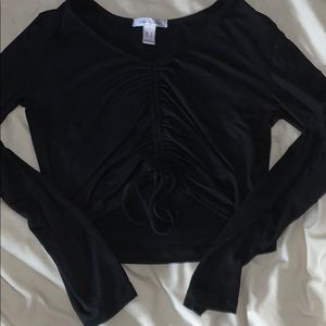 Cropped long sleeve top.